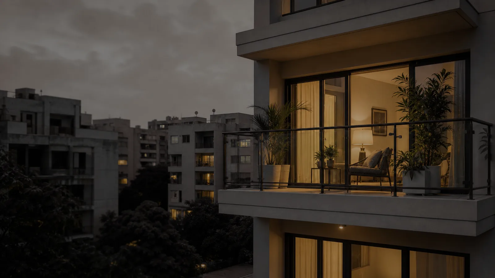A lit apartment seen from the balcony at dusk